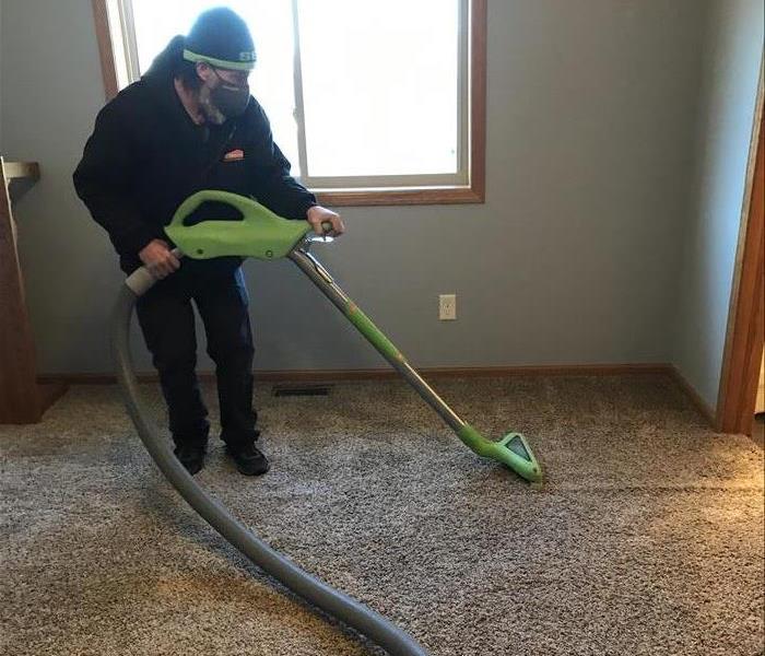 SERVPRO male employee using water extraction tool
