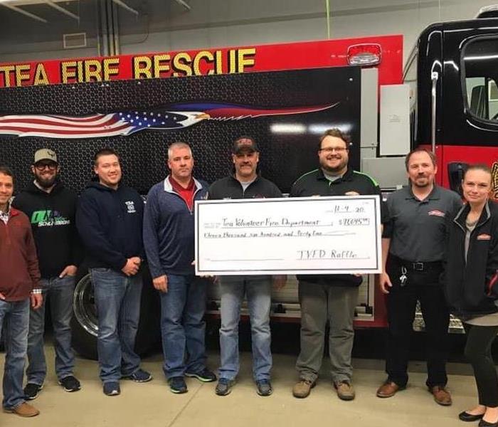 SERVPRO team presenting donation to Tea Fire Department