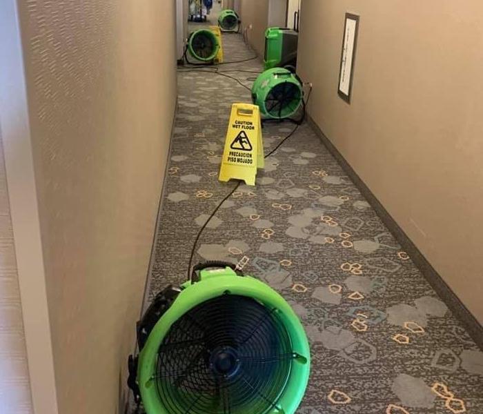 SERVPRO drying equipment placed in hotel hallway