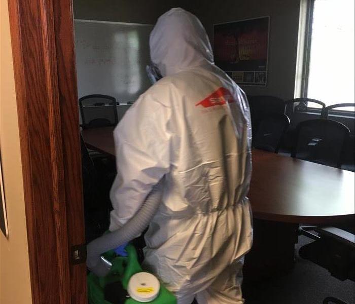 SERVPRO employee spraying disinfectant