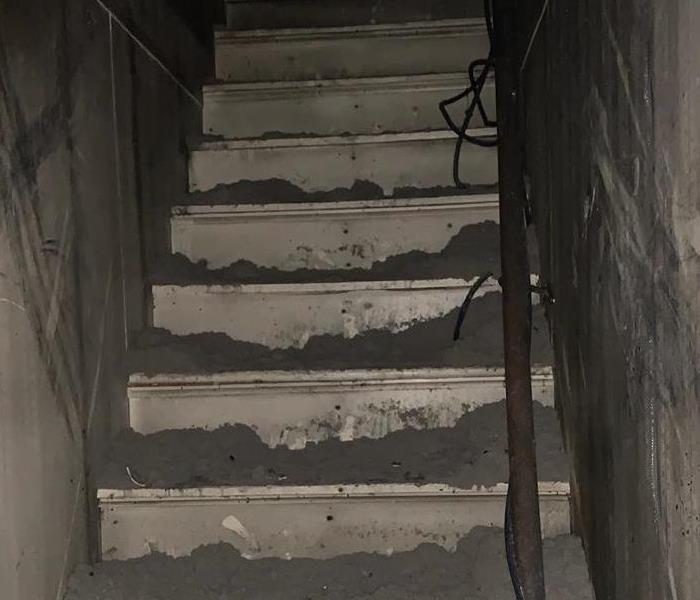 Stairwell in business blackened with soot and smoke damage. 
