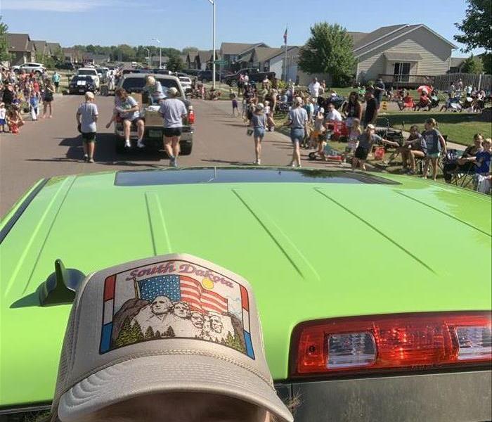 Servpro Employee Josh in a photo with crowd gathered for parade.